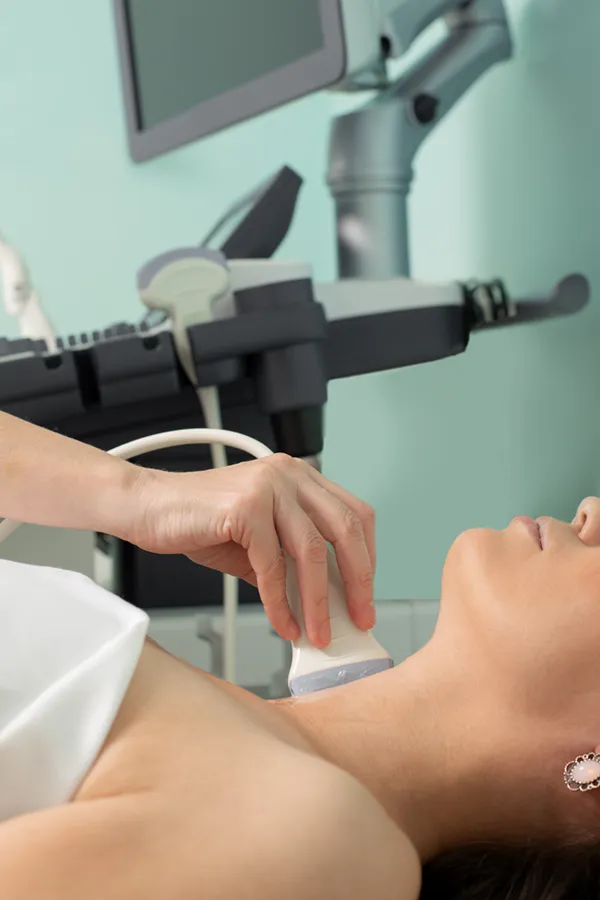 A woman gets a thyroid scan from a doctor in a clinic. Get help with Hashimoto's Thyroiditis from Tanya Zboril, NP of TBT Medical in Ottawa–Gatineau.