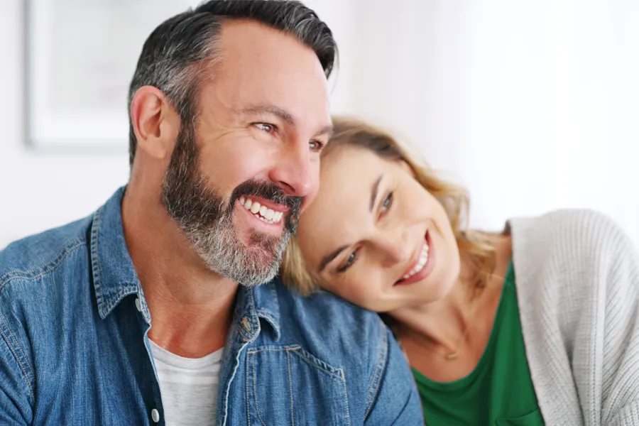 Health-and-Wellness-Services-Clinic-3 A middle-aged white couple in a bright white room smile and lay their heads on each other. Schedule concierge health and wellness services from Tanya Zboril, NP of TBT Medical in Ottawa–Gatineau.