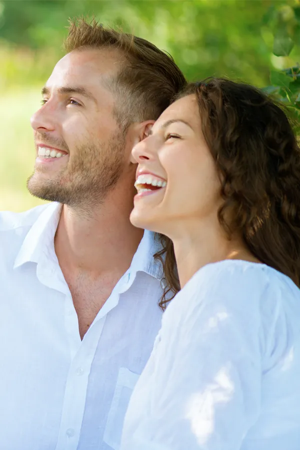 A couple smiles outside lit by the sunset. Get immunotherapy for autoimmune diseases from Tanya Zboril, NP of TBT Medical in Ottawa–Gatineau.
