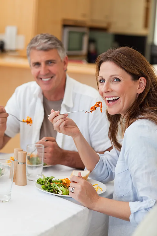 Improve digestion with Tanya Zboril, NP of TBT Medical's Functional Medicine for Leaky Gut Syndrome care in Ottawa–Gatineau, featuring a happy couple enjoying a nutritious lunch at home.