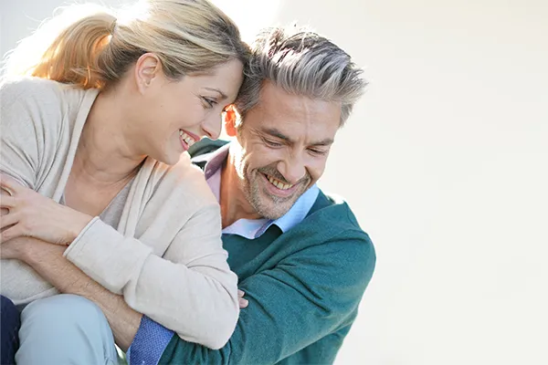 Metformin-Weight-Loss-Clinic A middle-aged couple embrace playfully on a sunny day. Get Metformin for weight loss treatment from Tanya Zboril, NP of TBT Medical in Ottawa–Gatineau
