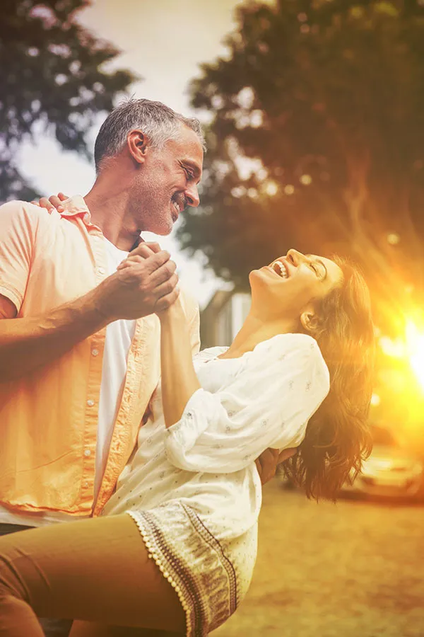 Metformin-Weight-Loss-Treatment A middle-aged couple dances playfully in the woods at sunset. Get Metformin for weight loss treatment from Tanya Zboril, NP of TBT Medical in Ottawa–Gatineau