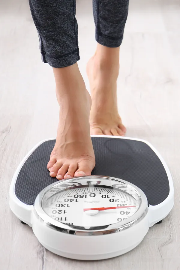 Close up of feet stepping onto a scale. Receive expert functional medicine for obesity treatment by Tanya Zboril, NP of TBT Medical in Ottawa–Gatineau.